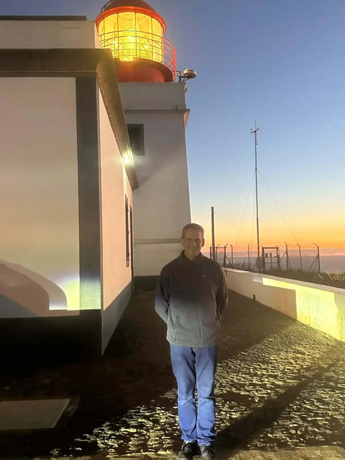 Illuminated Ponta do Pargo lighthouse at sunset