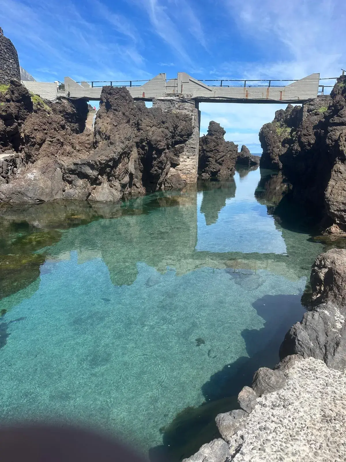 Clear volcanic natural pools and stone bridge in Porto Moniz