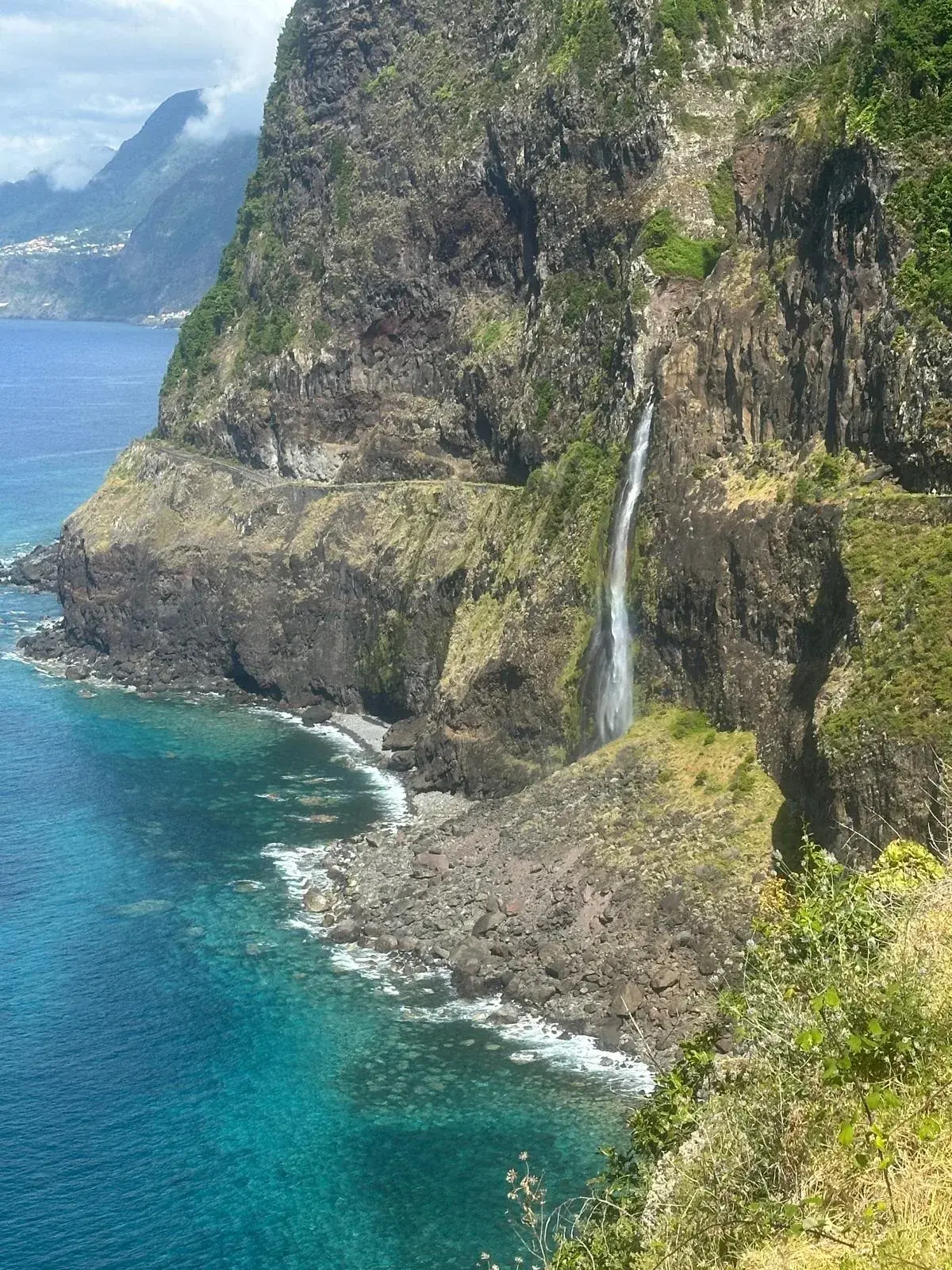Veu da Noiva waterfall dropping down Madeira north coast cliffs